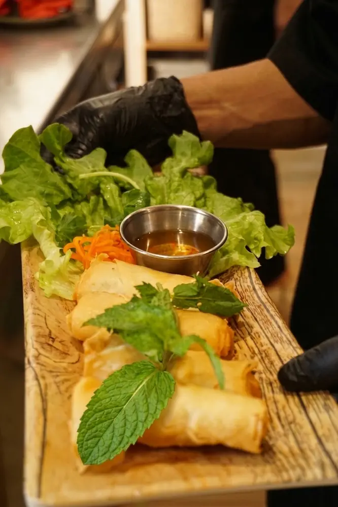 Nems croustillants servis avec menthe fraîche et salade